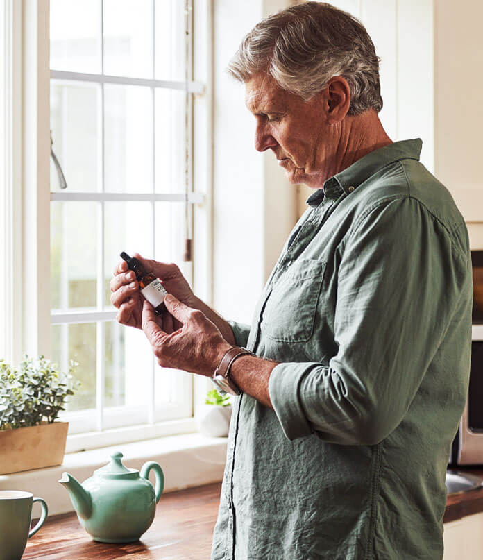 A man holding Marijuana bottle in his hands